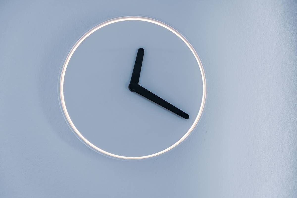 Smart clock wellness reminders glowing softly on bedside table with ambient light cues