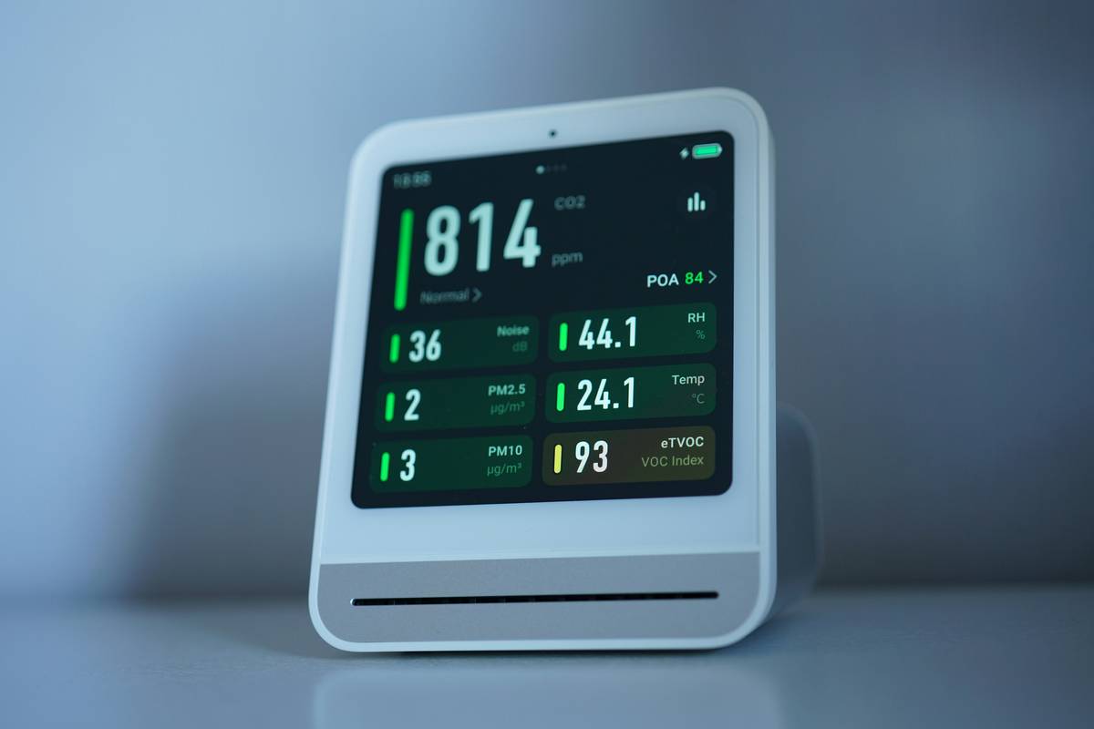 woman reviewing smart clock health analytics on mobile app connected to bedside device