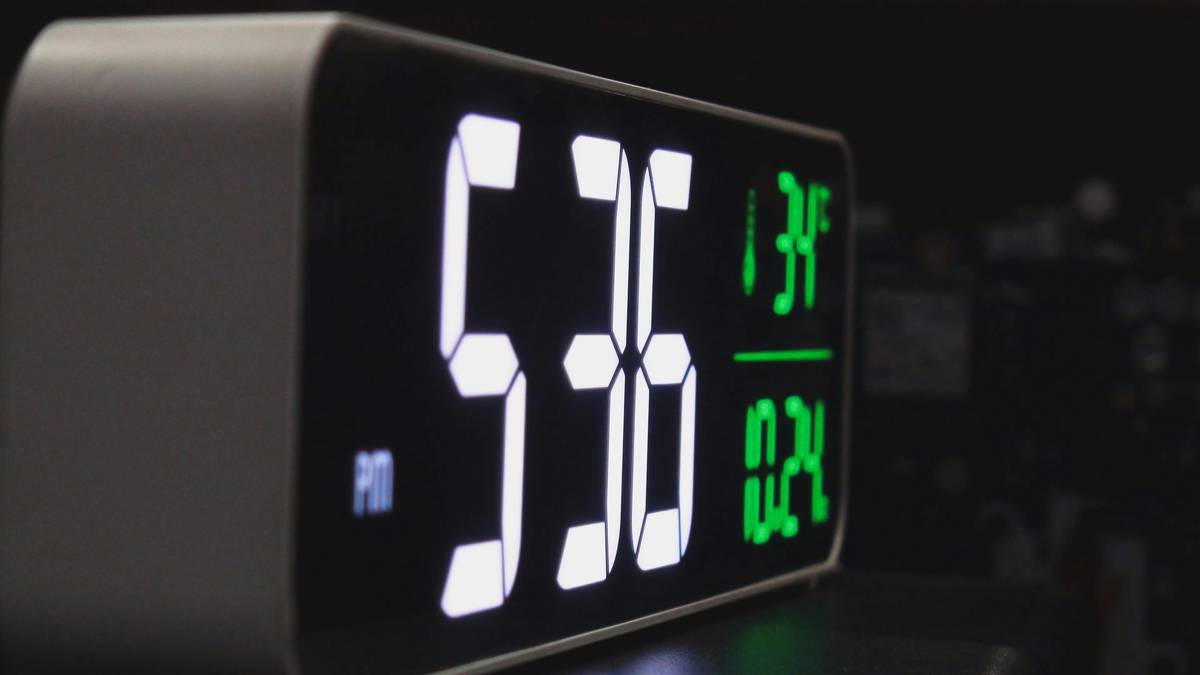 Side-by-side comparison of Lenovo Smart Clock, Echo Spot, and La Crosse View Station showing countdown visibility at 10-foot distance under kitchen lighting