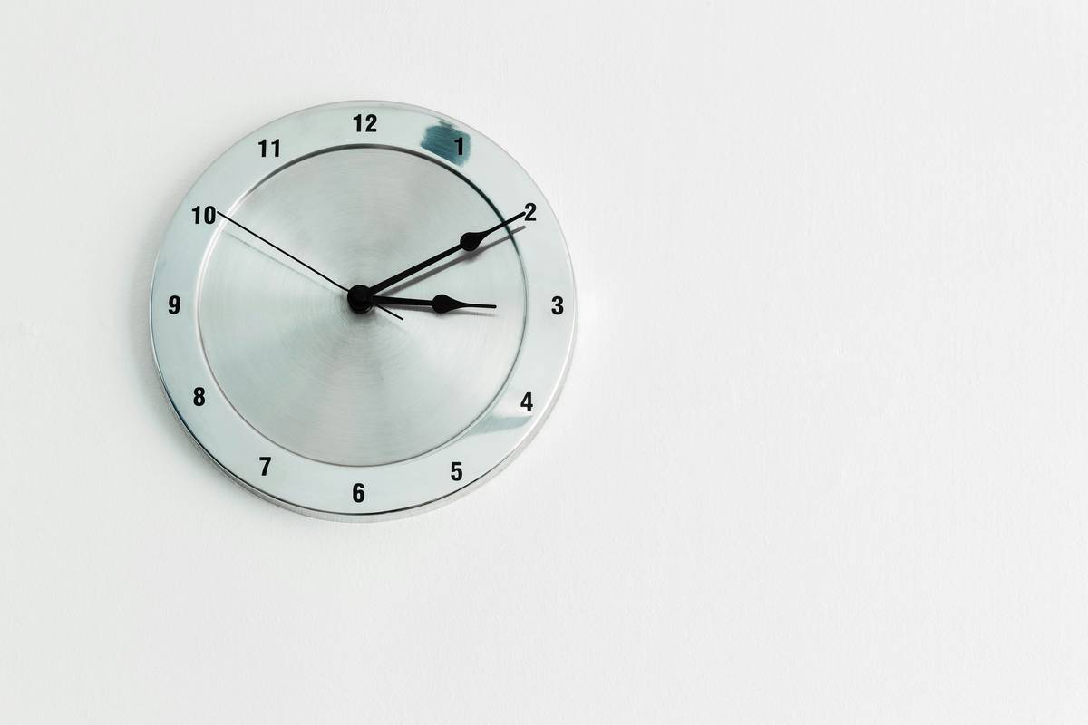 Modern bedroom with smart clock digital face showing customizable time and weather data on sleek black display